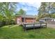 View of backyard with gray wooden deck and brick exterior at 809 Leon St, Durham, NC 27704