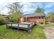 View of backyard with gray wooden deck and brick exterior at 809 Leon St, Durham, NC 27704