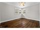 Bedroom features hardwood floors, natural lighting, and ceiling fan at 809 Leon St, Durham, NC 27704