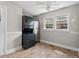 Kitchen with stackable washer dryer and stainless steel refrigerator. Natural light at 809 Leon St, Durham, NC 27704