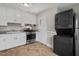 Galley kitchen with stainless steel range oven and appliances. Washer and dryer included at 809 Leon St, Durham, NC 27704