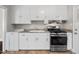 Practical kitchen featuring white cabinets, stainless steel range, neutral countertops, and a clean layout at 809 Leon St, Durham, NC 27704