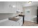 Functional kitchen with white cabinets, stainless steel range, and a windowed door to the backyard at 809 Leon St, Durham, NC 27704