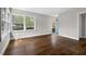 Spacious living room with hardwood floors, large windows offering plenty of natural light, and neutral wall colors at 809 Leon St, Durham, NC 27704