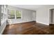 Spacious living room with hardwood floors, large windows offering plenty of natural light, and neutral wall colors at 809 Leon St, Durham, NC 27704