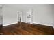 Spacious living room featuring hardwood floors, neutral walls, and an open entryway to the kitchen at 809 Leon St, Durham, NC 27704