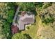 Aerial view of home showcasing its roof, patio, lush landscaping, and private wooded setting at 8304 Epping Forest Way, Wake Forest, NC 27587