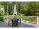 Outdoor deck with patio table and seating, perfect for enjoying the backyard at 8304 Epping Forest Way, Wake Forest, NC 27587