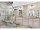 Elegant bathroom with glass shower, double vanities, and a neutral color scheme at 8304 Epping Forest Way, Wake Forest, NC 27587