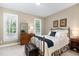 Comfortable bedroom with two windows, a brass bed frame, and soft carpet flooring at 8304 Epping Forest Way, Wake Forest, NC 27587