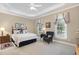 Inviting bedroom with a tray ceiling, soft carpet, and neutral decor, creating a relaxing atmosphere at 8304 Epping Forest Way, Wake Forest, NC 27587
