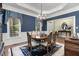 A charming dining room with a round table, six chairs, and windows with elegant window treatments at 8304 Epping Forest Way, Wake Forest, NC 27587