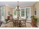 Bright dining area with a wooden table and chairs set, natural light, and neutral color palette at 8304 Epping Forest Way, Wake Forest, NC 27587