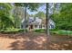 Beautiful white house with a welcoming front porch framed by mature trees and a well-manicured lawn at 8304 Epping Forest Way, Wake Forest, NC 27587