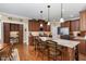 Well-appointed kitchen featuring an island with seating, custom cabinets, and stainless steel appliances at 8304 Epping Forest Way, Wake Forest, NC 27587
