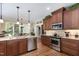 Modern kitchen with stainless steel appliances, granite countertops, and custom cabinetry at 8304 Epping Forest Way, Wake Forest, NC 27587