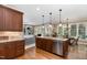 Open kitchen area with island, stainless steel appliances, and a view into the living room at 8304 Epping Forest Way, Wake Forest, NC 27587