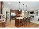 Spacious kitchen with a large island, granite countertops, stainless steel appliances, and hardwood floors at 8304 Epping Forest Way, Wake Forest, NC 27587