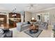 Open-concept living area flowing into kitchen, featuring comfortable seating and abundant natural light at 8304 Epping Forest Way, Wake Forest, NC 27587