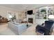 Cozy living room with built-in bookshelves, a fireplace, comfortable seating, and neutral color palette at 8304 Epping Forest Way, Wake Forest, NC 27587