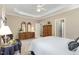 Spacious main bedroom boasts a tray ceiling and wooden furniture, providing ample storage at 8304 Epping Forest Way, Wake Forest, NC 27587