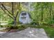 Quaint shed exterior featuring garden details and outdoor seating area in a wooded setting at 8304 Epping Forest Way, Wake Forest, NC 27587
