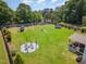 Aerial view of home featuring a large backyard with playground, trampoline, fire pit, and covered patio at 8616 Deep Elm Dr, Wake Forest, NC 27587
