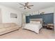 Comfortable bedroom featuring board and batten accent wall and cozy seating area at 8616 Deep Elm Dr, Wake Forest, NC 27587