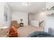 Carpeted bonus room with cozy furniture, shelving, and window with natural light at 8616 Deep Elm Dr, Wake Forest, NC 27587