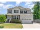 Charming two-story home with gray siding, black shutters, stone accents, and a well-manicured front lawn at 8616 Deep Elm Dr, Wake Forest, NC 27587