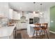 Kitchen with stainless steel appliances, white cabinetry, stone countertops and backsplash, and eat-in island with seating at 8616 Deep Elm Dr, Wake Forest, NC 27587
