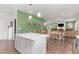 Open concept kitchen with white island, dining area, and living room, with hardwood floors throughout the home at 8616 Deep Elm Dr, Wake Forest, NC 27587