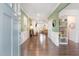 Open-concept living room with hardwood floors, green walls, white trim, and ample natural light at 8616 Deep Elm Dr, Wake Forest, NC 27587