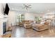 Open living area featuring a fireplace, tan sectional sofa, and views to the kitchen and backyard at 8616 Deep Elm Dr, Wake Forest, NC 27587