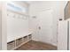 Mudroom entry with bench seating, storage baskets, hooks, and coat rack at 8616 Deep Elm Dr, Wake Forest, NC 27587