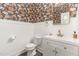 Elegant half bathroom features white wainscoting, floral wallpaper, and gold fixtures at 8616 Deep Elm Dr, Wake Forest, NC 27587