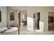 This bathroom features a soaking tub, marble floors, and a view of the walk-in closet and toilet at 909 Oberlin Rd, Raleigh, NC 27605