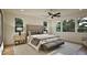 This main bedroom features a ceiling fan, carpet, and two bedside tables with lamps at 909 Oberlin Rd, Raleigh, NC 27605