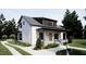 Stylish home featuring modern architecture, a covered porch, and manicured front yard at 909 Oberlin Rd, Raleigh, NC 27605