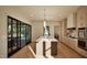 Modern kitchen with a center island, stainless steel appliances, and sliding door access to the patio at 909 Oberlin Rd, Raleigh, NC 27605