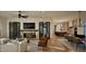 Open-concept living room featuring a stone fireplace, hardwood floors, and abundant natural light at 909 Oberlin Rd, Raleigh, NC 27605