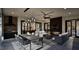Stylish outdoor living space with fireplace, ceiling fan, dining area, and seamless indoor-outdoor flow at 909 Oberlin Rd, Raleigh, NC 27605