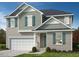 Charming two-story home with a two-car garage, gray siding, teal shutters, and well-maintained front yard at 936 Emmer St, Rolesville, NC 27571
