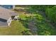 Aerial view of a home's spacious backyard, featuring a covered patio and a lush lawn at 94 Shooting Star Ln, Clayton, NC 27520
