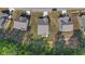 A detailed aerial shot showcases homes with neat driveways and landscaping, near a vibrant green space at 94 Shooting Star Ln, Clayton, NC 27520