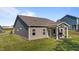 Well-maintained backyard with a covered patio featuring outdoor seating and lush green lawn at 94 Shooting Star Ln, Clayton, NC 27520
