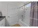 Bright bathroom with white tiled bathtub and shower, neutral walls, and light wood-look flooring at 94 Shooting Star Ln, Clayton, NC 27520