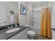 Well-lit bathroom with modern vanity, bathtub, shower and wood tile floors at 94 Shooting Star Ln, Clayton, NC 27520