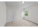 A bright bedroom features neutral walls, carpeted floors and a window providing natural light at 94 Shooting Star Ln, Clayton, NC 27520