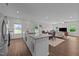 Open-concept kitchen featuring a spacious island, modern appliances, and hardwood flooring at 94 Shooting Star Ln, Clayton, NC 27520